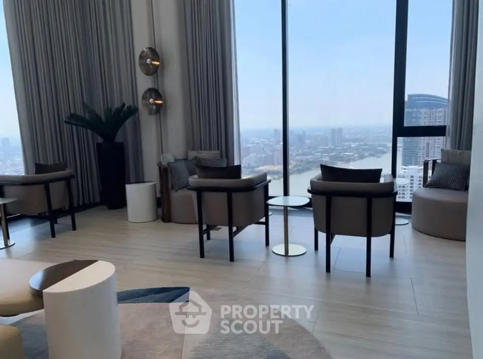 Luxurious high-rise living room with panoramic city views and elegant modern furnishings.