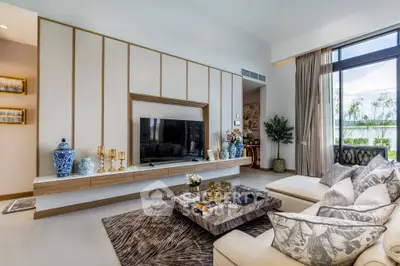 Luxurious living room with elegant decor and large windows offering natural light.