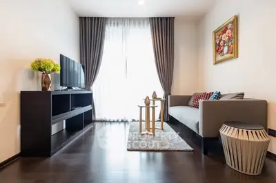 Modern living room with sleek furniture and elegant decor, featuring a cozy sofa and stylish TV stand.