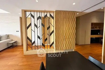 Modern living room with stylish wooden partition and sleek furniture