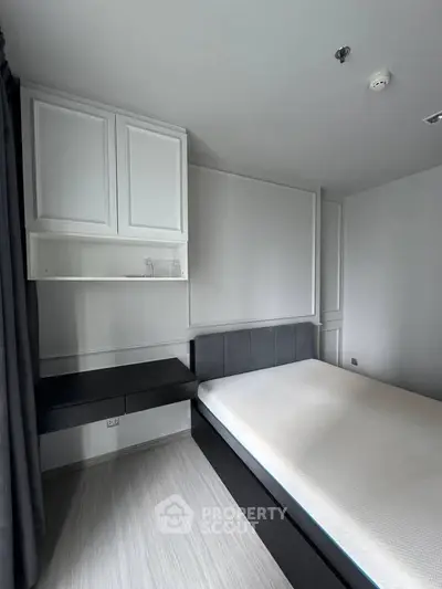 Modern minimalist bedroom with sleek design and ample storage space.