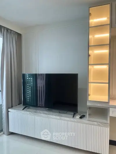 Modern living room with sleek TV unit and illuminated display shelves