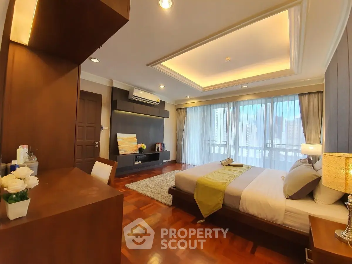 Luxurious bedroom with modern decor and large windows offering city views