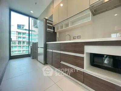 Modern kitchen with sleek cabinetry and appliances in a high-rise apartment