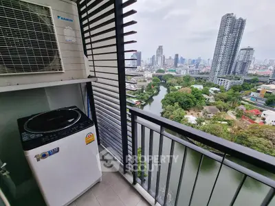 High-rise balcony with city view and washing machine, perfect urban living space.