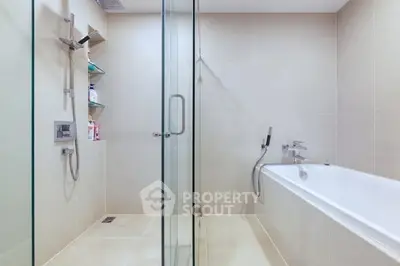 Modern bathroom with glass shower and bathtub in luxury apartment