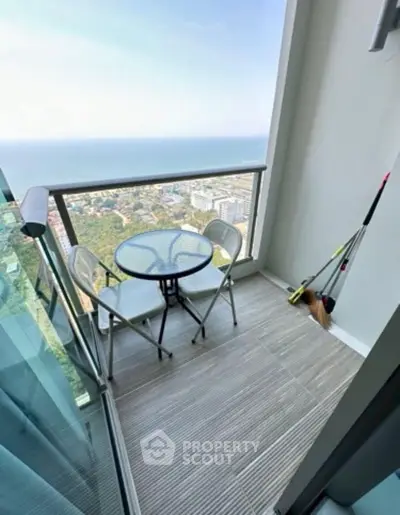 Stunning high-rise balcony with ocean view, perfect for relaxation and enjoying the scenery.
