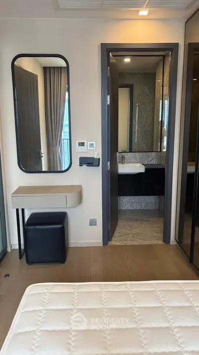 Modern bedroom with ensuite bathroom and stylish vanity area