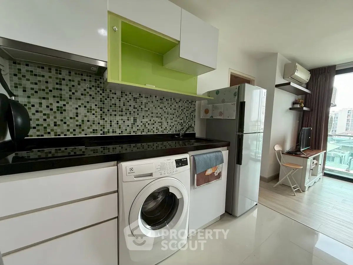 Modern kitchen with washing machine and open layout in stylish apartment