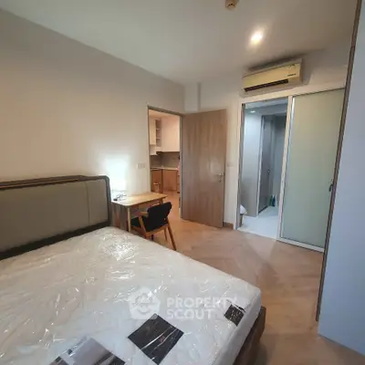 Modern bedroom with air conditioning and en-suite bathroom in stylish apartment