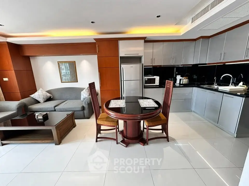 Modern open-plan kitchen and living area with sleek design and stylish furniture.