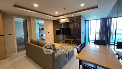 Spacious modern living room with dining area and balcony view in luxury apartment.