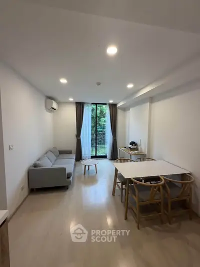Modern living room with natural light and stylish furniture in a cozy apartment.