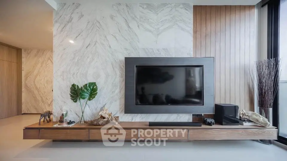 Modern living room with sleek TV setup and elegant wood paneling