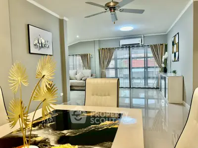 Spacious modern living room with elegant decor and large windows for natural light.