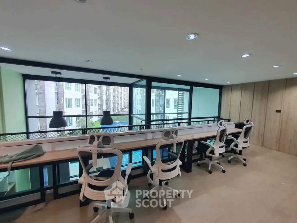 Modern co-working space with pool view and stylish seating