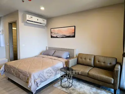 Modern bedroom with cozy sofa and stylish decor