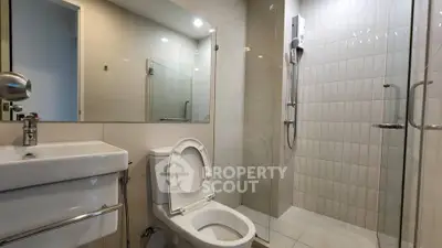 Modern bathroom with sleek fixtures and glass shower enclosure