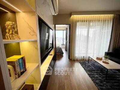Modern living room with elegant decor and city view, featuring a cozy seating area and stylish shelving.