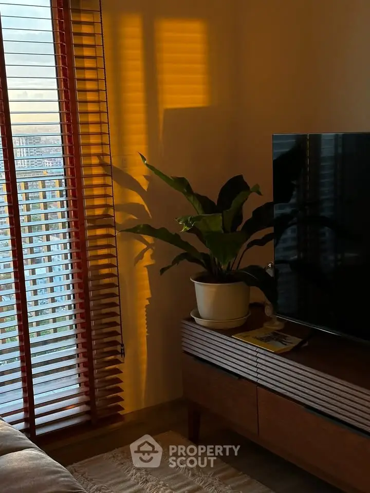 Cozy living room with modern TV stand and large window view