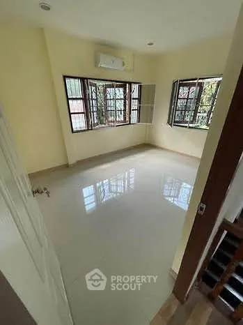 Spacious empty room with large windows and glossy floor, perfect for customization.