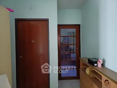 Cozy interior hallway with wooden doors and storage unit