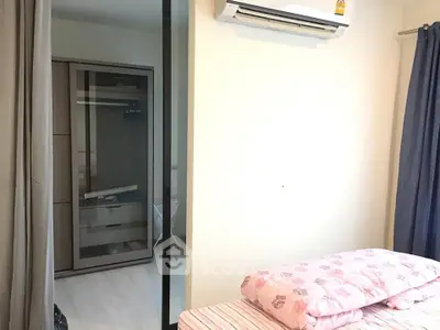 Cozy bedroom with air conditioning and wardrobe, perfect for comfortable living.