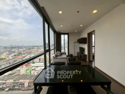 Stunning high-rise living room with panoramic city views and modern furnishings.