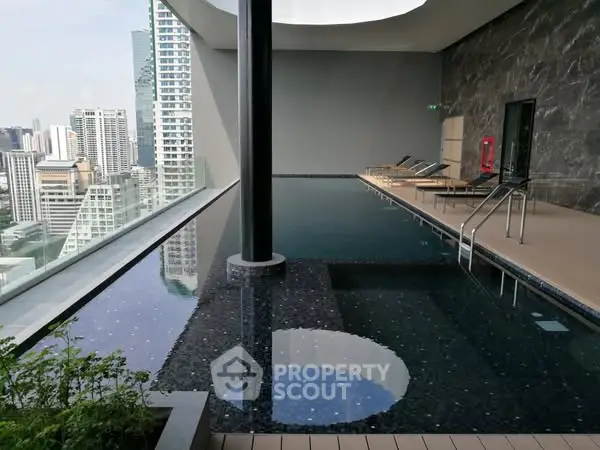 Luxurious rooftop pool with stunning city skyline view in modern high-rise building.