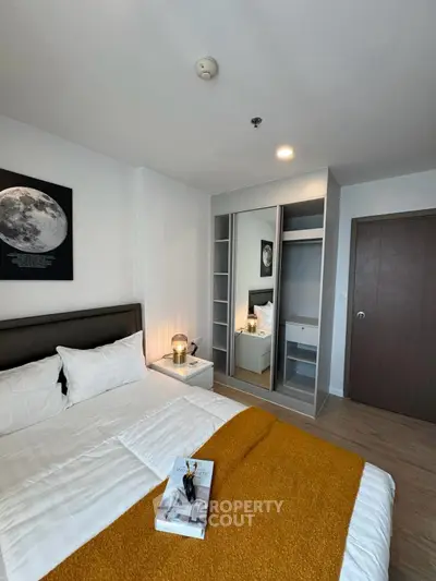 Modern bedroom with cozy decor and stylish wardrobe in a contemporary apartment.