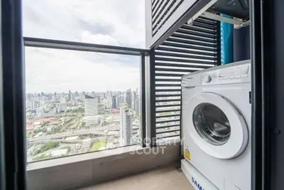 High-rise balcony with washing machine and stunning city skyline view.