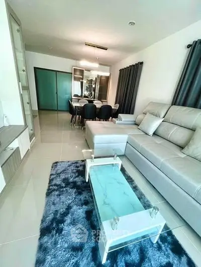 Modern living room with sleek furniture and elegant dining area