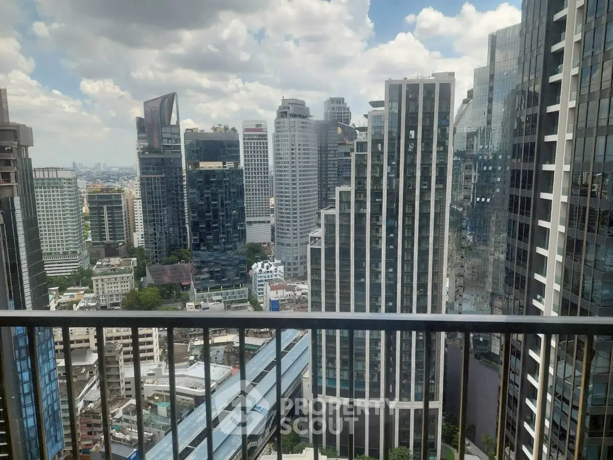Stunning cityscape view from a high-rise balcony overlooking modern skyscrapers and urban skyline.