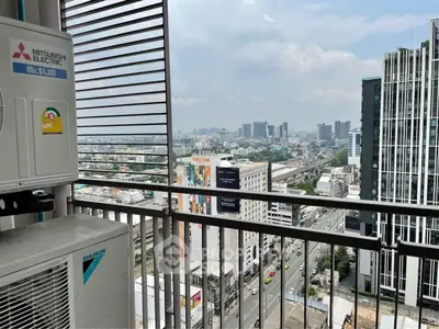 Stunning city view from high-rise balcony with modern air conditioning units.