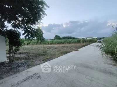 Spacious plot of land with lush greenery and clear skies, ideal for development opportunities.