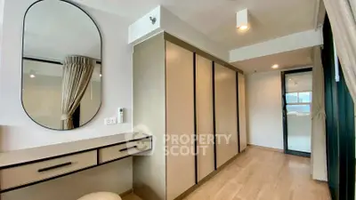 Modern bedroom with sleek wardrobe and stylish vanity in a bright apartment