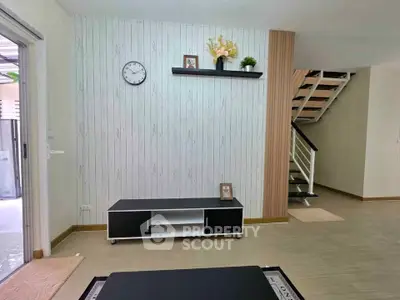Modern living room with stylish decor and staircase