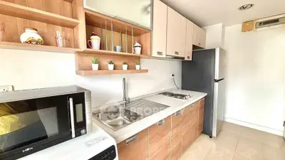 Modern kitchen with sleek cabinets, built-in appliances, and stylish decor in a bright, compact space.
