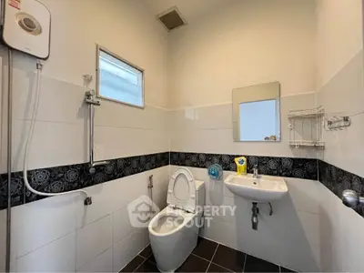 Modern bathroom with sleek fixtures and stylish black and white tile design.