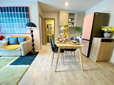 Modern open-plan living room and kitchen with stylish decor and dining area.
