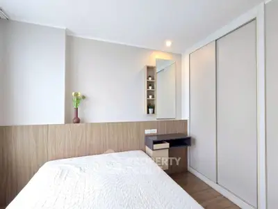 Modern bedroom with sleek design and built-in storage solutions.