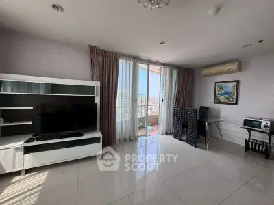 Spacious living room with modern furniture and balcony access in a bright apartment.