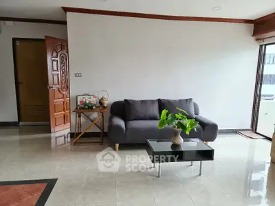 Modern living room with stylish sofa and coffee table in bright apartment