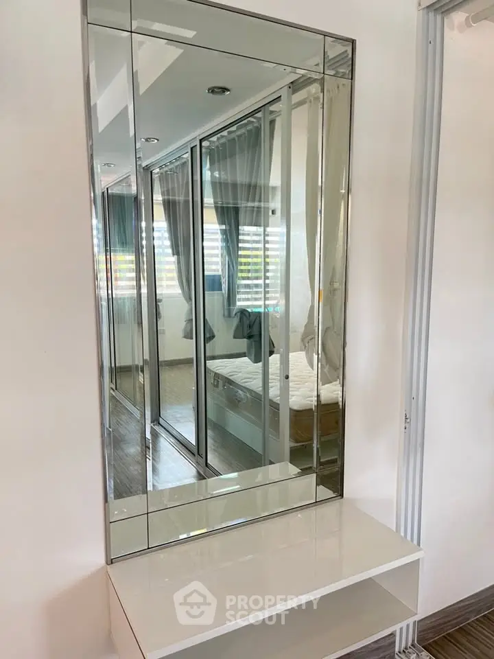Modern bedroom with mirrored wardrobe and sleek design