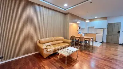 Modern living room with wooden flooring and open kitchen layout