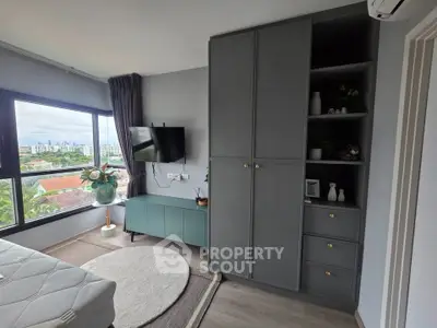 Modern bedroom with large window and stylish storage solutions