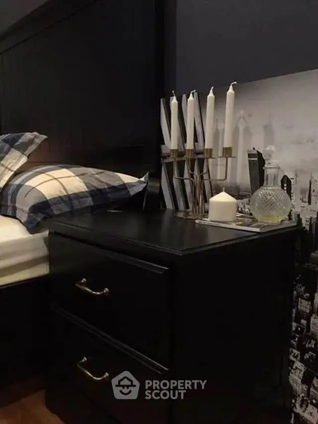 Stylish bedroom with elegant nightstand and decorative candles