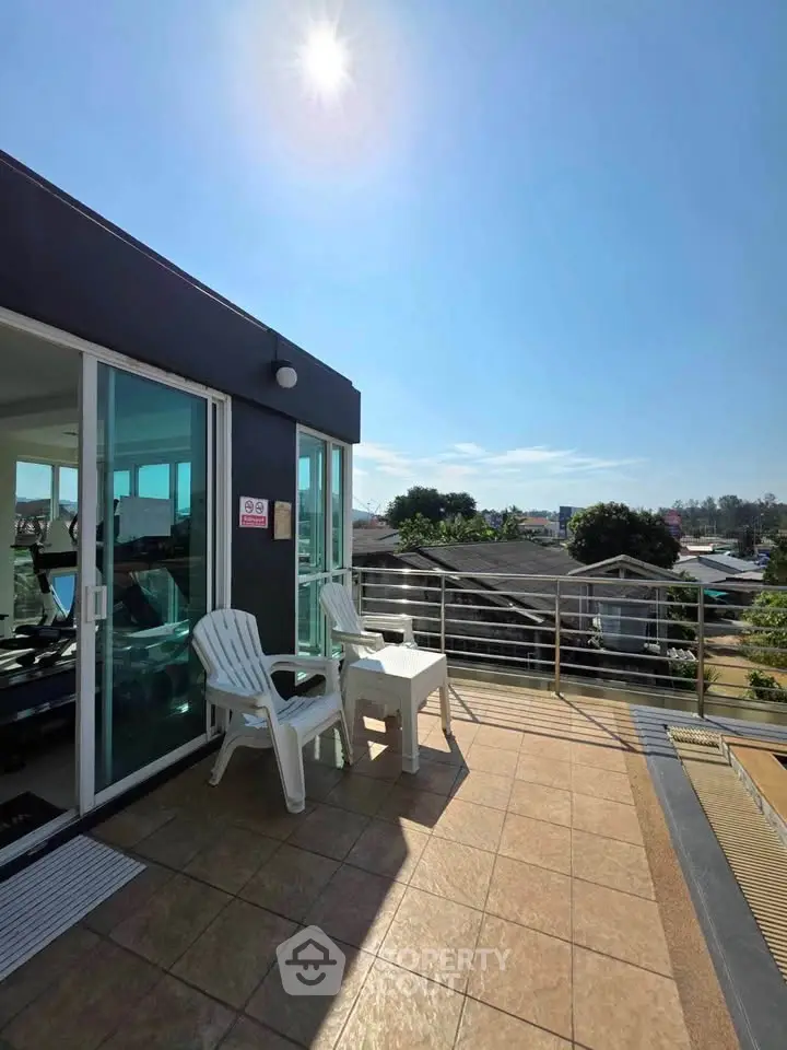 Spacious rooftop terrace with seating and panoramic views, perfect for relaxation and entertaining.