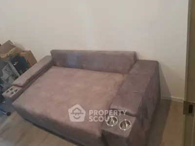 Spacious and inviting living area highlighted by a plush convertible sofa bed with built-in cup holders, perfect for relaxation or hosting guests.