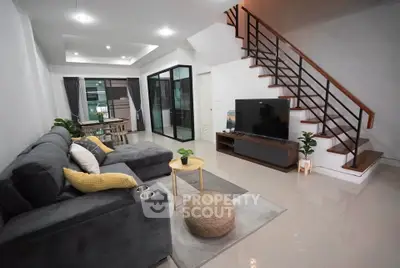 Spacious modern living room with stylish staircase and cozy seating area